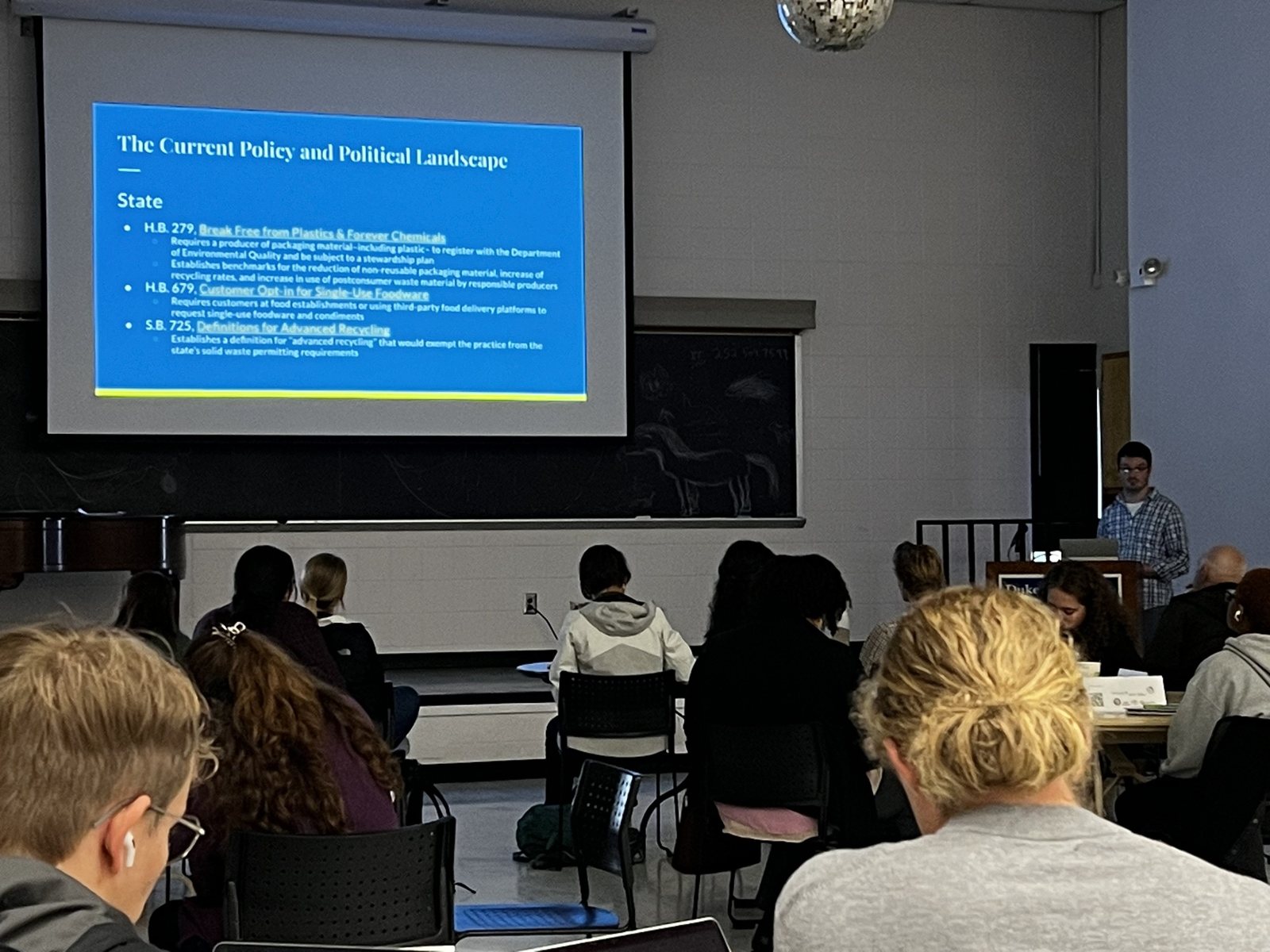 Speaker presenting to an audience about community policy