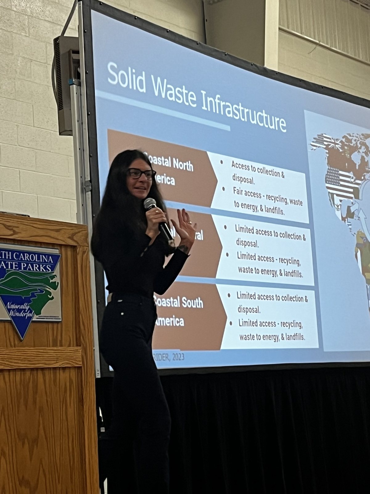 Presenter discussing solid waste infrastructure with an audience